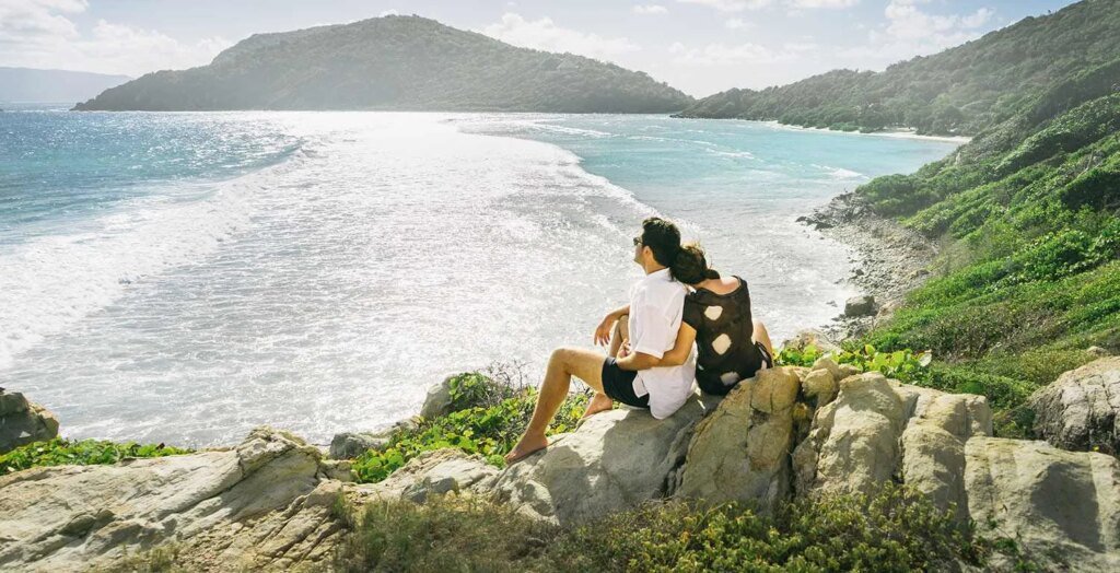 Scrub-Island-couple-sitting-on-vantage-point.jpg