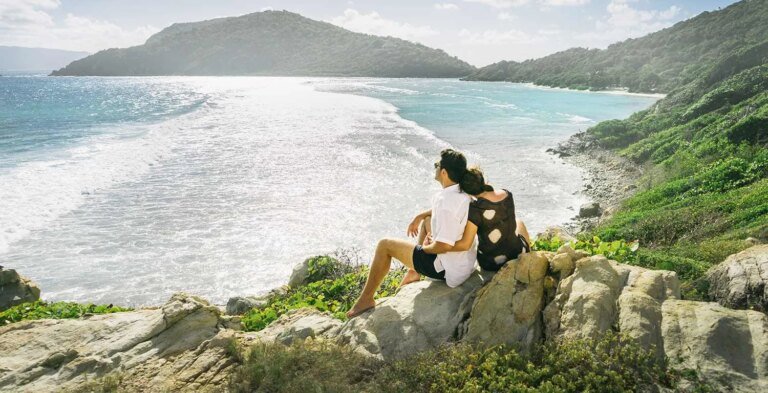 Scrub-Island-couple-sitting-on-vantage-point.jpg